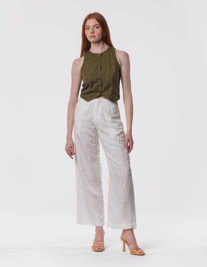 Model wearing high-waisted wide-leg linen pants in white with a relaxed fit and tailored waist by Artemizelle