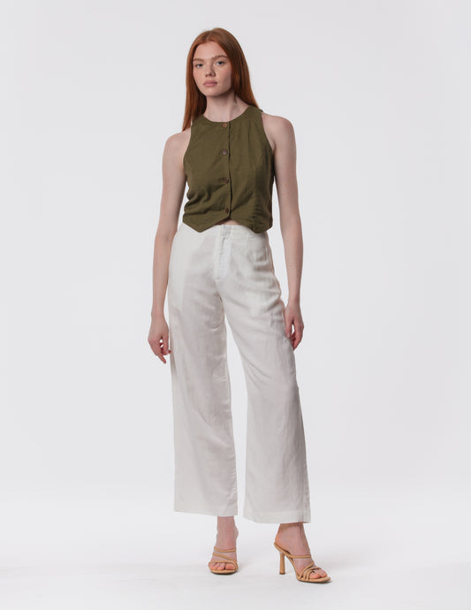 Model wearing high-waisted wide-leg linen pants in white with a relaxed fit and tailored waist by Artemizelle