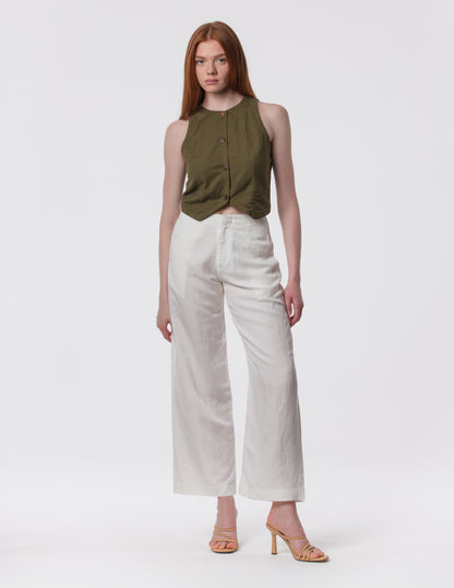 Model wearing high-waisted wide-leg linen pants in white with a relaxed fit and tailored waist by Artemizelle
