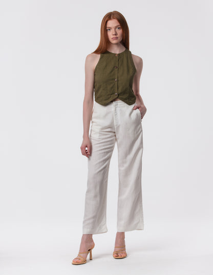Model wearing high-waisted wide-leg linen pants in white with a relaxed fit and tailored waist by Artemizelle