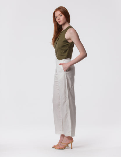 Model wearing high-waisted wide-leg linen pants in white with a relaxed fit and tailored waist by Artemizelle
