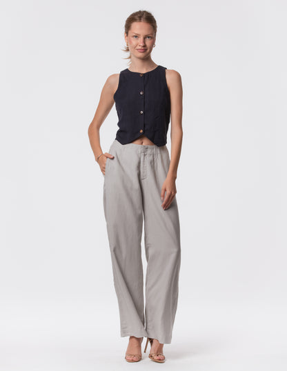 Model wearing high-waisted wide-leg linen pants in gray with a relaxed fit and tailored waist by Artemizelle