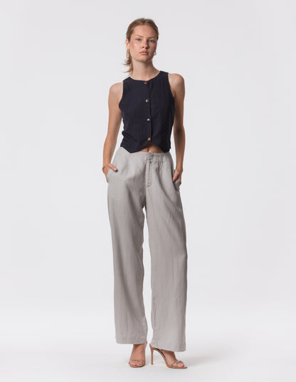 Model wearing high-waisted wide-leg linen pants in gray with a relaxed fit and tailored waist by Artemizelle