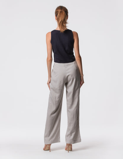 Model wearing high-waisted wide-leg linen pants in gray with a relaxed fit and tailored waist by Artemizelle