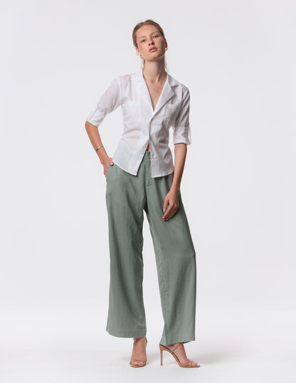 Model wearing high-waisted wide-leg linen pants in Green with a relaxed fit and tailored waist by Artemizelle