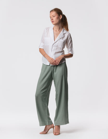 Model wearing high-waisted wide-leg linen pants in Green with a relaxed fit and tailored waist by Artemizelle